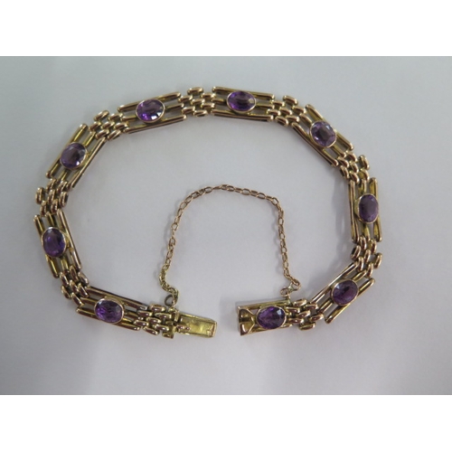 39 - A 9ct yellow gold amethyst bracelet - approx weight 11 grams - slight wear mainly to stones