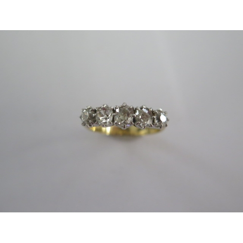 40 - An 18ct yellow gold and platinum five stone diamond ring - the central diamond approx 0.24ct - ring ... 