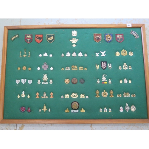 401 - A well presented collection of Rhodesia Military cap and cloth badges including SAS - frame size 64c... 