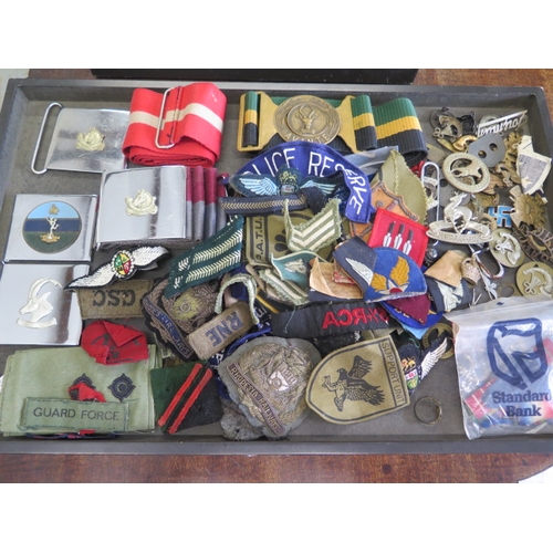 404 - A collection of assorted Military badges, belts and buckles