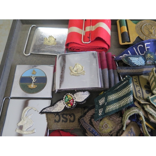 404 - A collection of assorted Military badges, belts and buckles