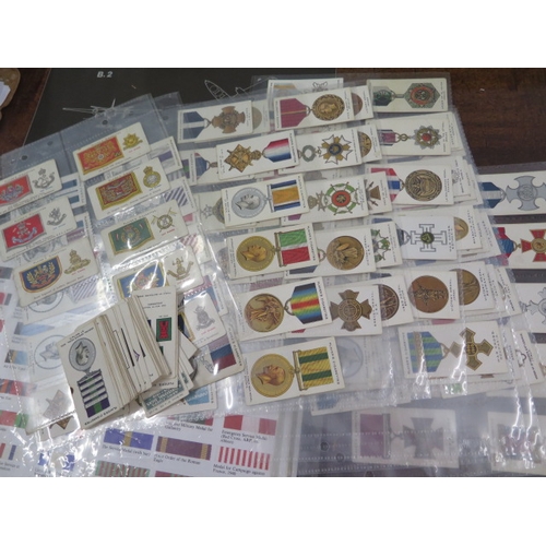 407 - A collection of assorted Militaria including badges, buttons, cigarette cards etc