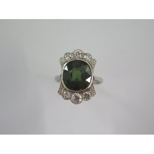 42 - An 18ct white gold and platinum diamond and green stone ring size M - head 19mm x 13mm - diamonds br... 