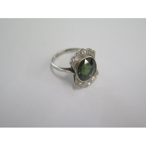 42 - An 18ct white gold and platinum diamond and green stone ring size M - head 19mm x 13mm - diamonds br... 