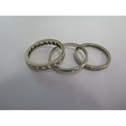 46 - An 18ct white gold band ring size M - approx weight 1.8 grams - and two white metal eternity rings s... 