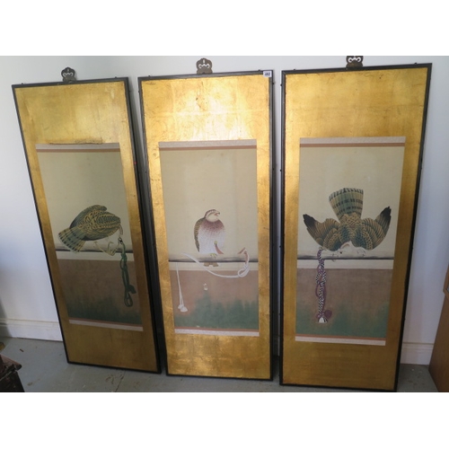 492 - Three Oriental bird of prey scrolls mounted on a gilt background in ebonised frames, frame size 141c... 