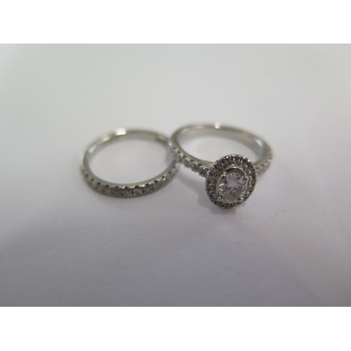 50 - A platinum and diamond cluster ring with a central 0.32ct diamond - Colour F, Clarity VS - ring size... 