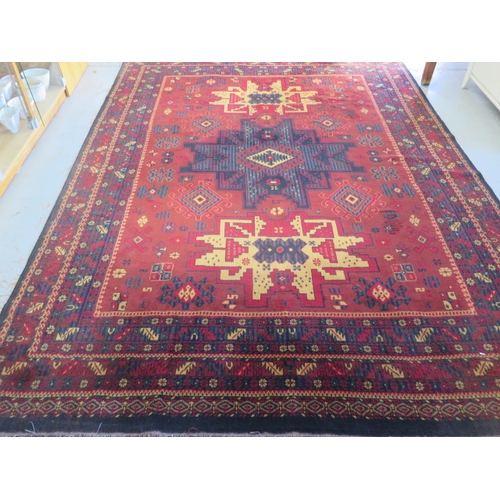 525 - A Saint-Maclon woollen rug with a red field - 356cm x 252cm