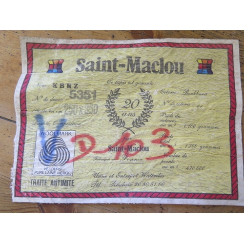 525 - A Saint-Maclon woollen rug with a red field - 356cm x 252cm