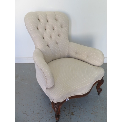 562 - A recently reupholstered Victorian button back walnut fireside armchair - in good condition