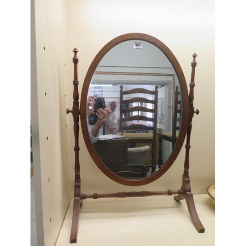 563 - A mahogany oval dressing mirror on stand - Height 69cm x Width 49cm