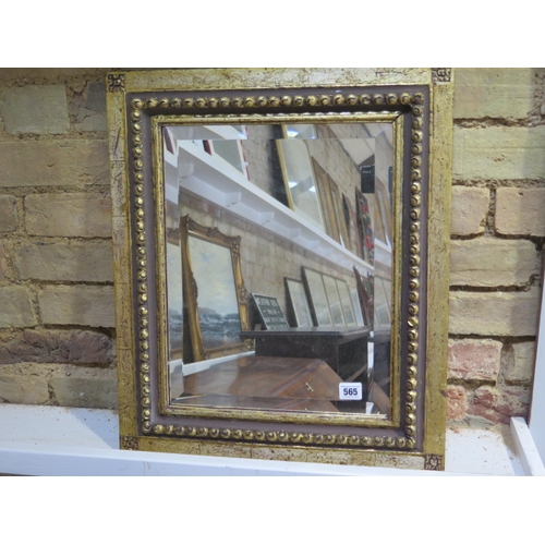 565 - A gilt wall mirror with bevelled edged glass - 56cm x 47cm