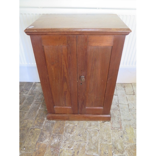 578 - A 19th century pitch pine cupboard with two panelled doors and three internal shelves 92 cm tall x 6... 