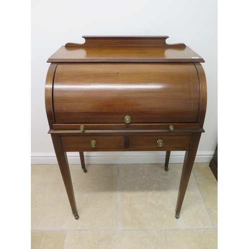 581 - An Edwardian inlaid mahogany cylinder top writing desk with a fitted interior over two frieze drawer... 