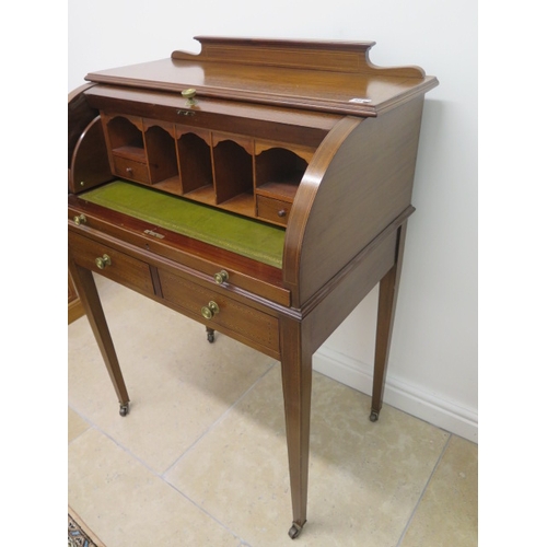 581 - An Edwardian inlaid mahogany cylinder top writing desk with a fitted interior over two frieze drawer... 