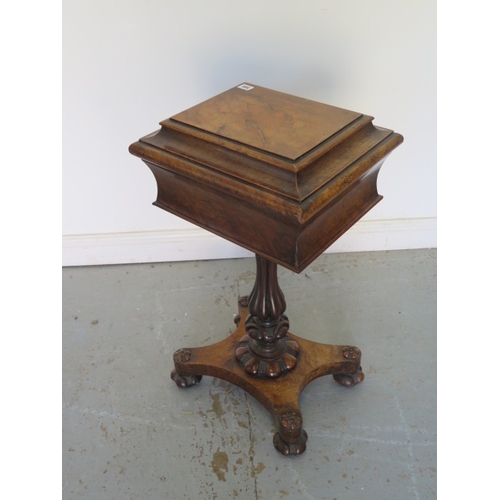 585 - An early Victorian walnut teapoy on a shaped column and quatrefoil platform base with relined interi... 