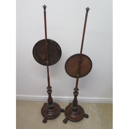 588 - A pair of mahogany pole fire screens with needlework designs - Height 145cm