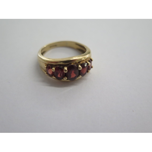 59 - A 9ct yellow gold five stone garnet ring size Q - approx weight 4.6 grams - in good condition