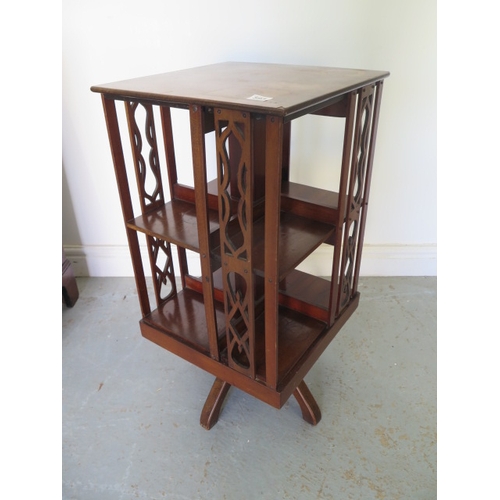 593 - A small mahogany rotating bookcase - Height 75cm x 38cm x 38cm