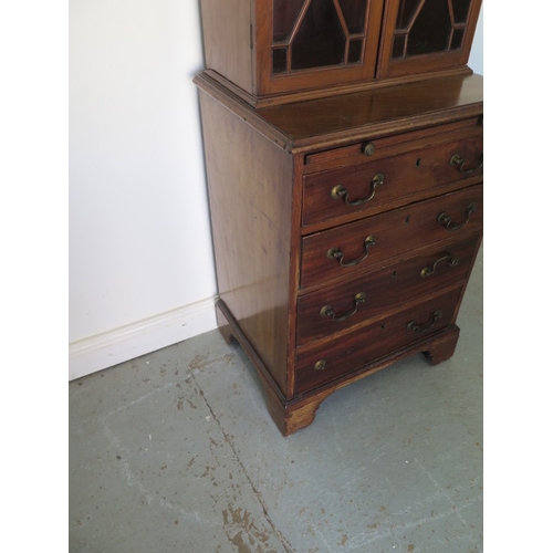 595 - A mahogany bookcase chest with a two door astragal glazed top over a four drawer chest with a brushi... 