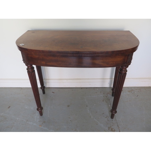 596 - A 19th century mahogany foldover card table on turned reeded legs - Height 74cm x Width 91cm