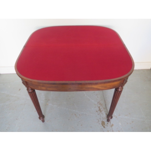 596 - A 19th century mahogany foldover card table on turned reeded legs - Height 74cm x Width 91cm