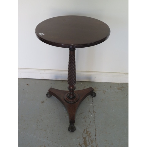 597 - A mahogany wine table on a turned fluted column, platform base and cast iron claw feet - Height 73cm... 