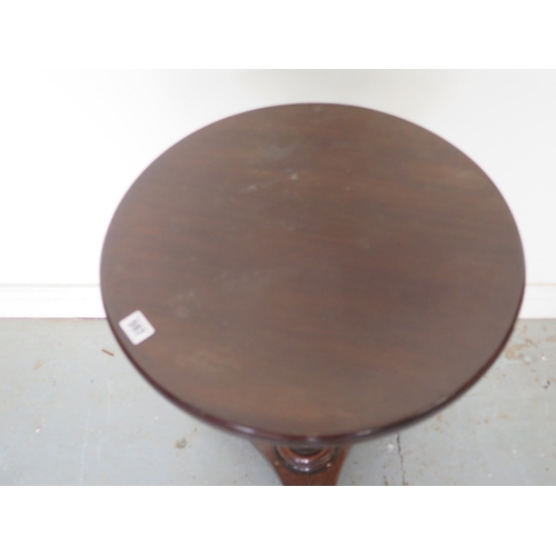 597 - A mahogany wine table on a turned fluted column, platform base and cast iron claw feet - Height 73cm... 