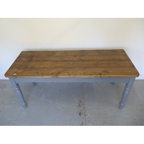 600 - A pine kitchen table with a painted base and thick four plank top - Height 77cm x 178cm x 70cm