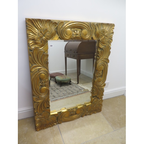 605 - A modern ornate gilt mirror - 112cm x 87cm - in good condition