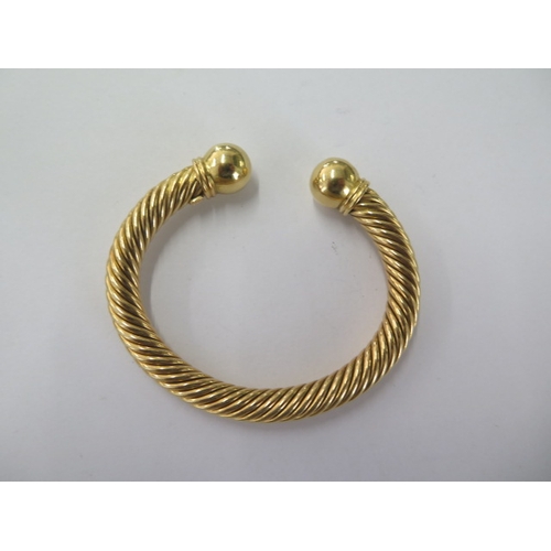 65 - An 18ct 750 yellow gold rope twist torque bangle - approx weight 46 grams - in good condition