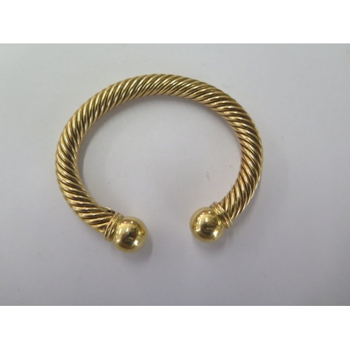 65 - An 18ct 750 yellow gold rope twist torque bangle - approx weight 46 grams - in good condition