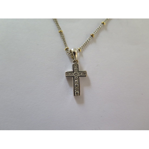 71 - An 18ct white gold diamond crucifix on an 18ct yellow and white gold 42cm chain - good condition - a... 