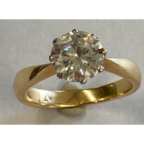 An 18ct yellow gold and platinum solitaire diamond ring - the round brilliant cut diamond approx 1.57ct, colour J/K, SI2/P1 assessed - ring size N - approx weight 4.5 grams - in good condition, some wear to inner shank, with a valuation for insurance £11,600 dated 2017