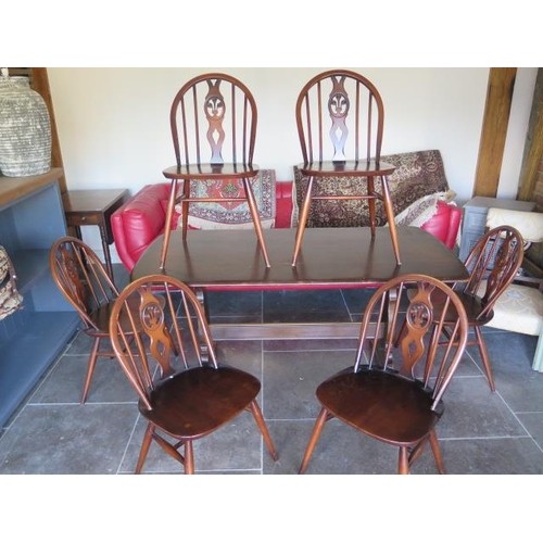 618 - A vintage Ercol dining table and six matching chairs - 150cm x 75cm