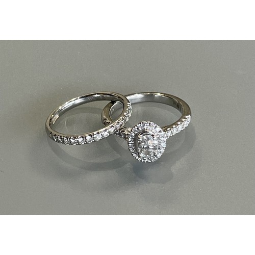 50 - A platinum and diamond cluster ring with a central 0.32ct diamond - Colour F, Clarity VS - ring size... 