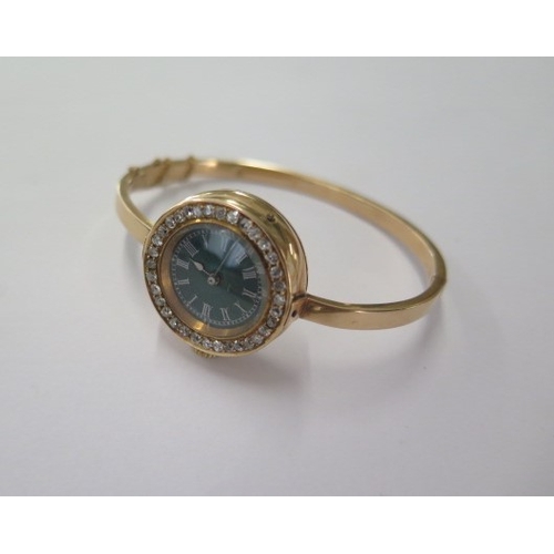 17 - A diamond set gilt metal manual wind wristwatch on a later hollow hinged bangle - 25mm case - total ... 