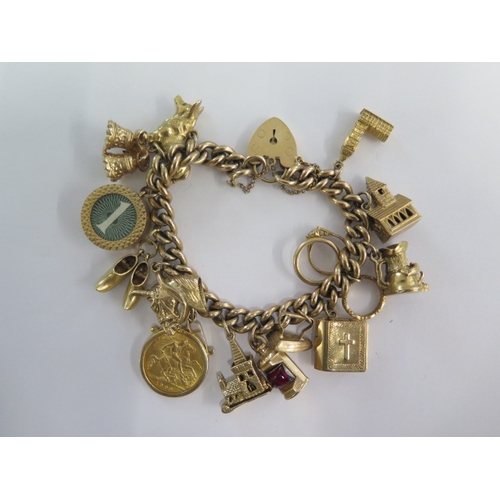 70 - A 9ct yellow gold charm bracelet with an Edward VII gold half sovereign dated 1909 with 13 charms - ... 