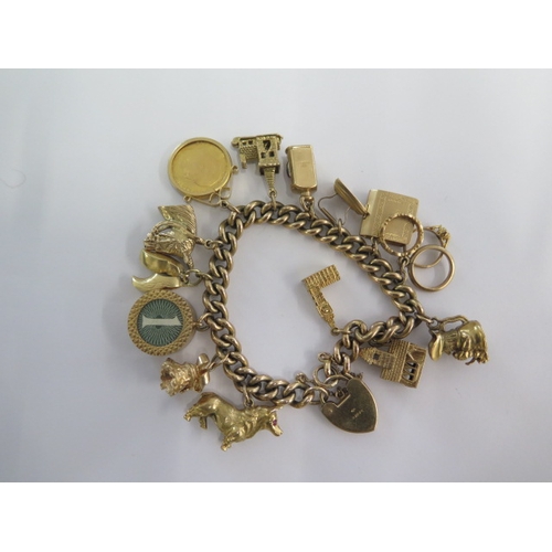 70 - A 9ct yellow gold charm bracelet with an Edward VII gold half sovereign dated 1909 with 13 charms - ... 