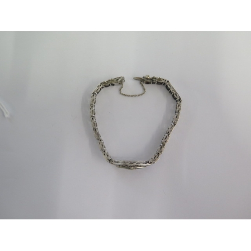 72 - A white metal Art Deco diamond and emerald bracelet - head size 24mm x 10mm - approx weight 9.4 gram... 