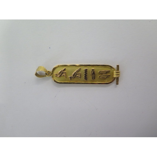 73 - An 18ct yellow gold Egyptian pendant - Length 43mm - approx weight 1.9 grams