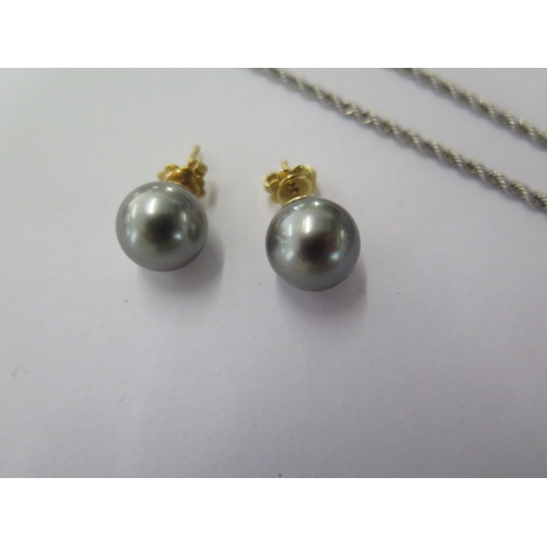 118 - A white metal diamond set tear drop black pearl pendant on an 18ct white gold 42cm chain along with ... 