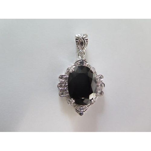 119 - A 9ct white gold black spinel pendant - Length 4cm - approx weight 10.7 grams - in good condition, w... 