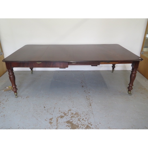 560 - A mahogany pull out dining table with two leaves on turned legs - extends from 120cm to 230cm x 74cm... 