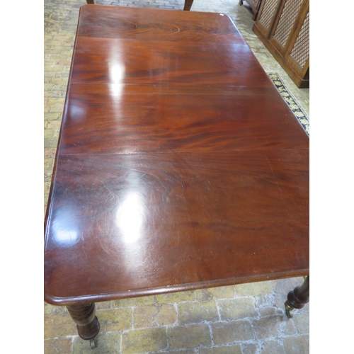 560 - A mahogany pull out dining table with two leaves on turned legs - extends from 120cm to 230cm x 74cm... 