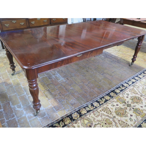 560 - A mahogany pull out dining table with two leaves on turned legs - extends from 120cm to 230cm x 74cm... 