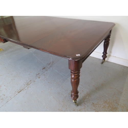 560 - A mahogany pull out dining table with two leaves on turned legs - extends from 120cm to 230cm x 74cm... 