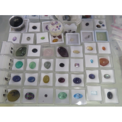 104 - A large collection of loose gem stones including opals, quartz, citrine, tourmaline - with painted i... 