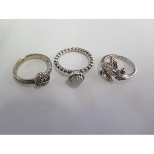 106 - Two Pandora silver rings sizes K and L and a Clogau rolled gold ring size J - all generally good