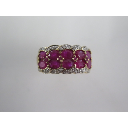 128 - A ten stone ruby and diamond 9ct yellow gold ring - head size 22mm x 11mm - ring size S